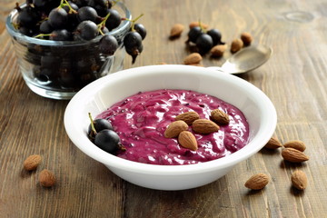 Tasty black currant smoothie with almonds and fresh berries