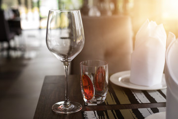 Reserved sign on a table in restaurant. Empty glasses set in restaurant