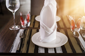 Reserved sign on a table in restaurant. Empty glasses set in restaurant