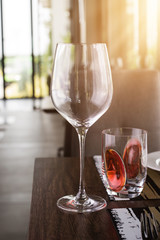 Reserved sign on a table in restaurant. Empty glasses set in restaurant