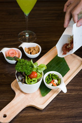 Fried Pork with Garlic. Deep Fried Crispy Pork Belly Cooked with Garlic and spicy dipping sauce on wooden table background