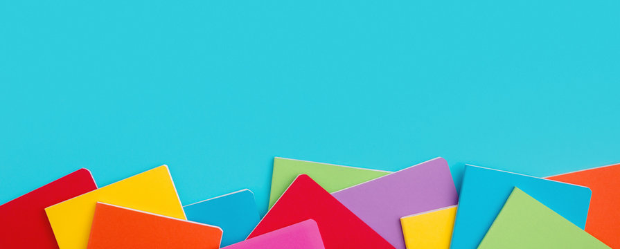 School notebooks over blue background.