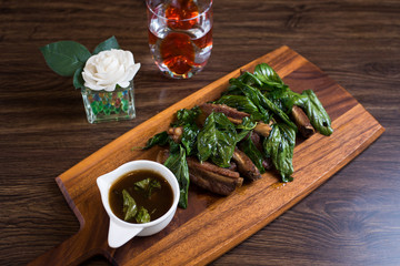 Deep fried sour pork spare rib bone on wood