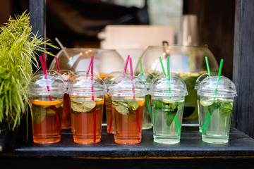 Fresh lemonade with lime and mint in plastic cups