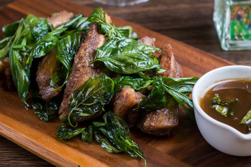 Deep fried sour pork spare rib bone on wood