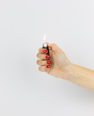 black lighter with fire in woman's hand isolated on white background