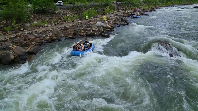 Rafting down first rapid in whitewater river.