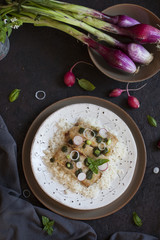 Slices of fried Nile perch with pesto and rise.