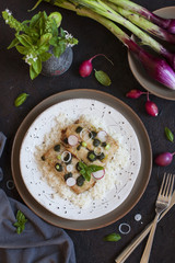 Slices of fried Nile perch with pesto and rise.