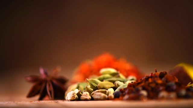 Spice. Various Indian spices and herbs rotated on wooden table. 4K UHD video 3840x2160
