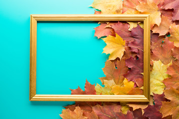 Arranged wooden frame on blue surface with leaves