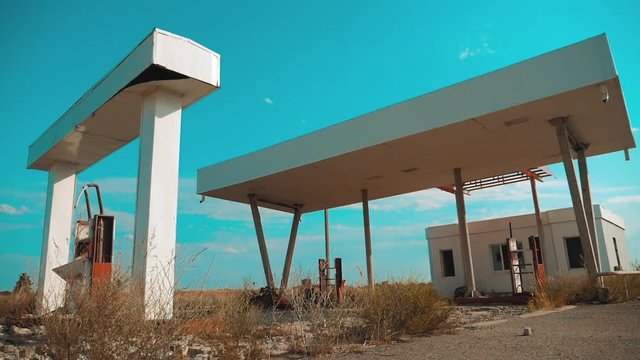 Old dirty deserted gas station lifestyle. U.S. Route 66. crisis road 66 fueling slow motion video. closed supermarket store shop Abandoned gas station oil end of fuel the world apocalypse petrol. main