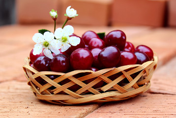 cherry ripe juicy with a flower lies in the basket