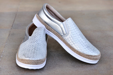  Trendy silver moccasins. Fashionable women's leather shoes.Beauty and fashion concept. 