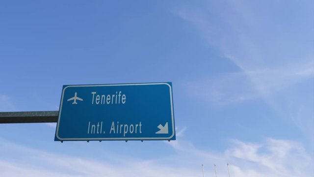 tenerife airport sign airplane passing overhead