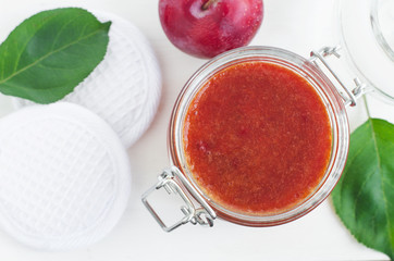 Homemade plum smoothie face and body mask/scrub in a glass jar. DIY cosmetics and spa. Copy space.  