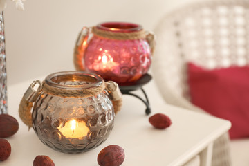 Candles in glass holders on table