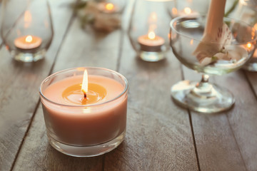 Obraz na płótnie Canvas Beautiful burning candle on wooden table