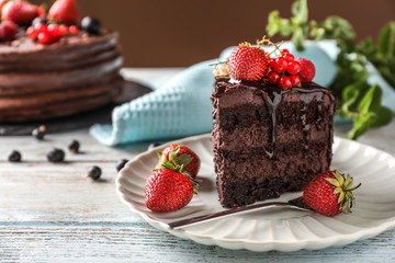 Piece of delicious chocolate cake with berries on plate