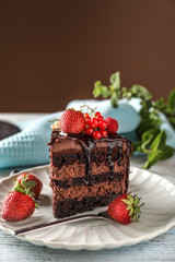 Piece of delicious chocolate cake with berries on plate