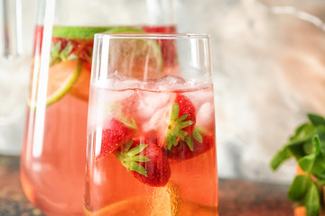 Natural lemonade with strawberry in glass on table, closeup