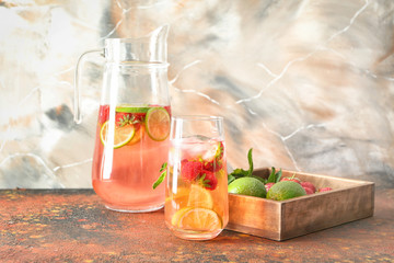 Composition with tasty strawberry lemonade on table