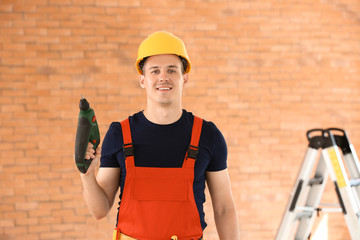 Electrician with drill indoors