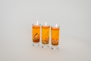 Three decorative candles for home decoration on white background.