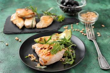 Plate with tasty grilled chicken fillet and ripe avocado on table