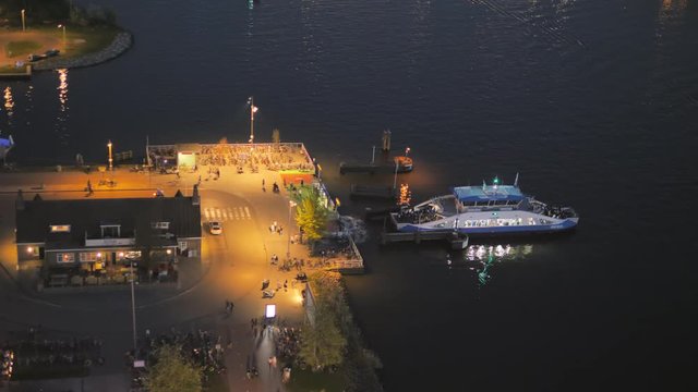 Amsterdam,01/06/2018:ferry leaving the dock at night aerial view