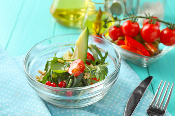 Glass bowl with tasty vegetable salad on table