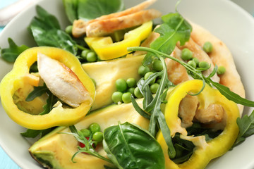 Tasty grilled chicken fillet and vegetables in bowl, closeup