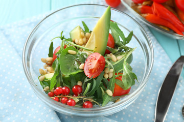 Glass bowl with tasty vegetable salad on table