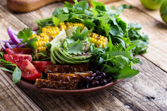 Bowl with abocado and colorful vegetables, healthy vegan meal