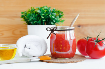 Homemade tomato face mask in a glass jar. Diy cosmetics. Copy space.