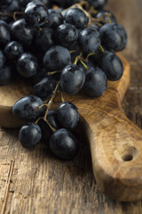 Dark grape on wooden desk