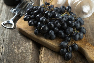 Dark grape on wooden desk