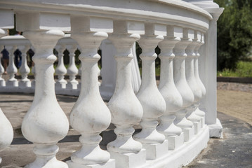 white railing in the background of columns