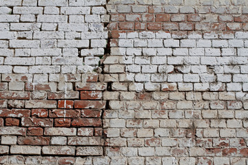 Old cracked red-white brick wall as background, texture