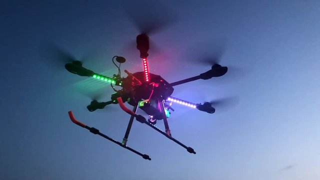 Slow Motion shot of a hovering hi tech drone fitted with infra red camera