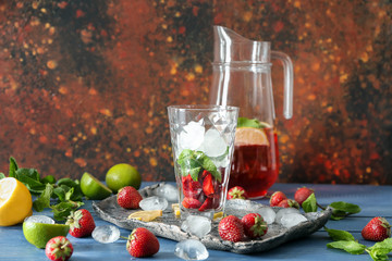 Composition with tasty strawberry lemonade on table