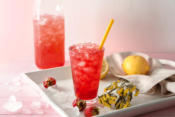 Glass of tasty strawberry lemonade on tray