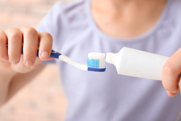Little girl with toothbrush and paste, closeup