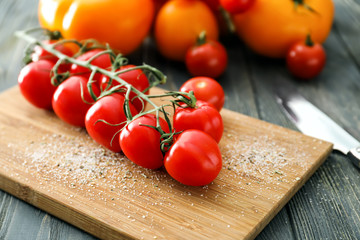 Fresh cherry tomatoes on wooden board