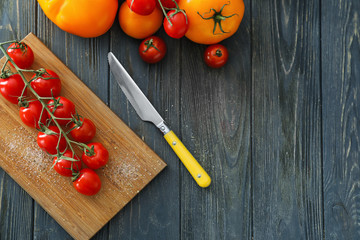 Different fresh tomatoes on wooden table