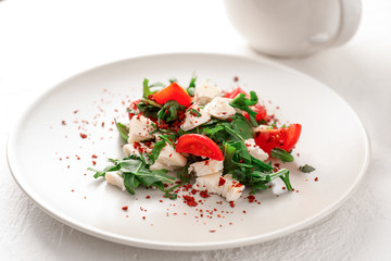Fresh salad with cherry tomatoes and mozzarella cheese on plate