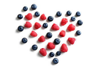 Heart made of delicious ripe berries on white background