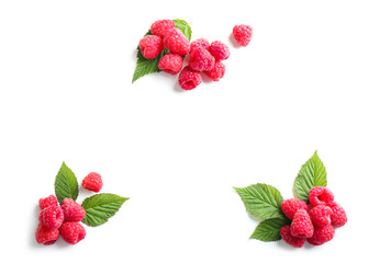 Delicious ripe raspberries with leaves on white background