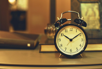 Naklejka premium alarm clock on bedroom nightstand