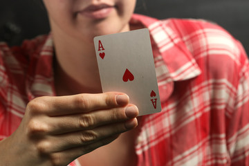 Woman is holding heart ace card